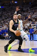 May 24, 2024; Minneapolis, Minnesota, USA; Dallas Mavericks guard Luka Doncic (77) controls the ball against Minnesota Timberwolves forward Jaden McDaniels (3) in the fourth quarter during game two of the western conference finals for the 2024 NBA playoffs at Target Center. Mandatory Credit: Jesse Johnson-USA TODAY Sports