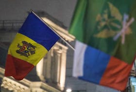 The state flag of Moldova (L) flies outside the country's embassy in central Moscow, Russia December 18, 2017.