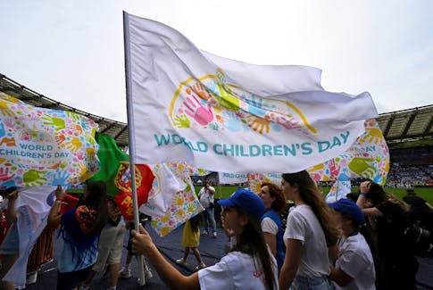A child holds a flag on the day of the celebration of the first ''World Children's Day'' attended by Pope Francis at the Olympic stadium in Rome, Italy, May 25, 2024.