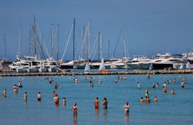 Tourists bathe in El Arenal beach in Palma de Mallorca, Spain, May 25, 2024.