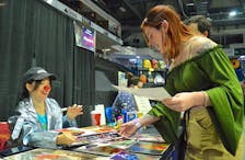 Sam Smith, right, smiles as she receives her autographed photo from actress Alyson Court, who was one of the special guests at CaperCon on Sunda ythis year. Best known for playing Loonette on “The Big Comfy Couch,” has been a voice actor in animated version of the Resident Evil, Beetlejuice and X-Men franchises.