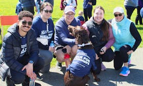 More than 200 walkers turned up in the sunshine for the IG Wealth Management Walk for Alzheimer’s at Open Hearth Park in Sydney Sunday. From left are a group of walkers from Grant Thornton: Ramy Ramaban, Amanda Miller, Sylvie Gerbasi, Annalisa Leon and Charlotte DeViller. In front is chocolate lab Oakley. The goal of $25,000 was exceeded. More than 16,000 people in Nova Scotia are living with dementia. BARB SWEET/CAPE BRETON POST