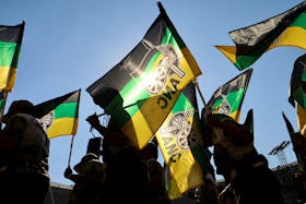 Supporters of the African National Congress (ANC) wave party flags during their final rally ahead of the upcoming election at FNB stadium in Johannesburg, South Africa, May 25, 2024.