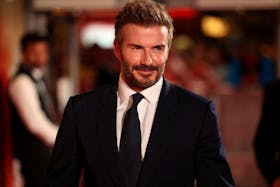 Former Manchester United player David Beckham poses on the red carpet before '99' World Premiere