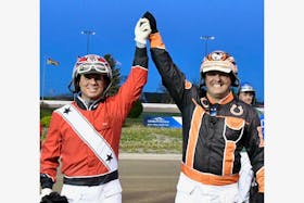 P.E.I.’s David Dowling, left, and Nova Scotia’s Redmond Doucet, raise their arms in the air after earning the right to represent the Atlantic region at the national driving championship in Trois-Rivieres, Que., on July 5. Doucet finished first and Dowling came second in the Atlantic regional driving championship, held as part of an 11-dash harness racing card at Red Shores Racetrack and Casino at the Charlottetown Driving Park on May 25. - Gail MacDonald/Special to SaltWire
