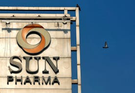 A bird flies past the logo of Sun Pharma installed on the facade of its corporate office in Mumbai, India, November 14, 2017.