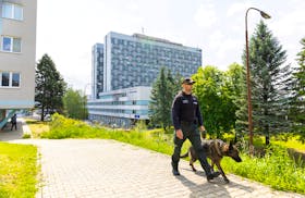 A police officer with a dog inspects the area around the F.D. Roosevelt University Hospital, where Slovak Prime Minister Robert Fico is hospitalised following an assassination attempt, in Banska Bystrica, Slovakia, May 19, 2024.