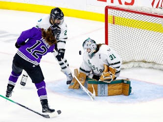 Aerin Frankel of Boston makes a save against Kelly Pannek  of Minnesota in the third period in Game 4r of the PWHL Finals.