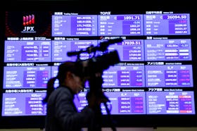 File photo: A media person stands in front of the stock quotation board during a ceremony marking the end of trading in 2022 at the Tokyo Stock Exchange (TSE) in Tokyo, Japan December 30, 2022.