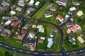 Residential houses can be seen along a road in a suburb of Auckland in New Zealand, June 24, 2017. Picture taken June 24, 2017.  