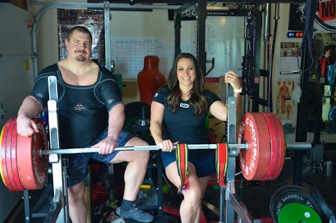 John MacDonald, left, and his partner, Jillian Sproul, take a break from training at their Charlottetown home. MacDonald and Sproul are both representing Canada at the International Powerlifting Federation (IPF) bench press world championships in Austin, Texas, this week. Jason Simmonds • The Guardian