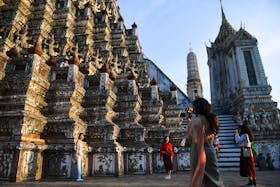 Tourists from mainland China dressed in traditional Thai costumes visit Wat Arun temple ahead of the Chinese Lunar New Year as China reopens the border in Bangkok, Thailand January 18, 2023.
