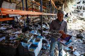 Sergii Polituchyi, Ukrainian publisher and businessman, shows an example of a book for kids at his printing house, which was badly damaged by a recent Russian missile strike, amid Russia's attack on Ukraine, in Kharkiv, Ukraine May 26, 2024.