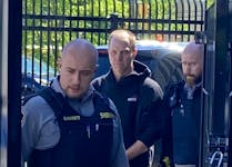 Michael Anders McKinney is led to a sheriff's van Wednesday after appearing in Dartmouth provincial court on a charge of manslaughter. McKinney will return to court next Tuesday for a bail hearing.