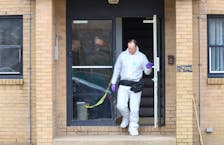 A Halifax Regional Police forensics officer investigates the death of 56-year-old Ronald Edward Howell at an apartment building at 65 Pinecrest Dr. in Dartmouth on March 25. Following an autopsy, the death was ruled a homicide. Police announced Wednesday that Michael Anders McKinney, 47, has been charged with manslaughter.