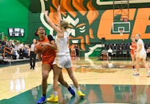 Darah Fleurgin of the Cape Breton Capers, left, looks to the basket during Atlantic University Sport women’s basketball action at Sullivan Field House in Sydney last season. The Capers will begin the 2024-25 AUS season in early November in Sydney. CONTRIBUTED/VAUGHAN MERCHANT, CBU ATHLETICS