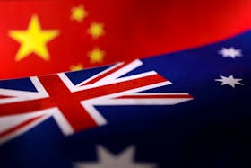 Printed Chinese and Australian flags are seen in this illustration, July 21, 2022.