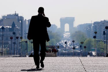 A businessman walks on the esplanade of La Defense, in the financial and business district in La Defense, west of Paris, April 10, 2014.  