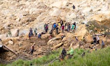People clear an area at the site of a landslide in Yambali village, Enga Province, Papua New Guinea, May 27, 2024.   UNDP Papua New Guinea/Handout via REUTERS