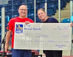 MS Walk coordinator Kyle Peterson accepts a check from Petra Buis, manager of the Royal Bank in North Sydney. The Cape Breton leg of the MS Walk received RBC’s Community Builder grant of $1,500. CONTRIBUTED.