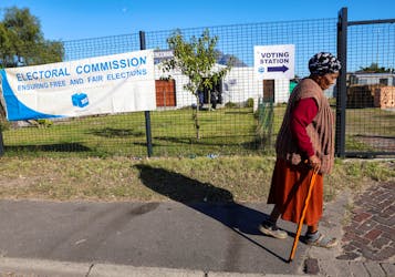 An elderly lady walks past a voting station during a special voting day, ahead of South Africa's general elections to elect a new National Assembly, in Cape Town, South Africa, May 27, 2024