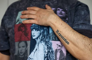 Roberto Santos, 55, a Spanish superfan who is part of a select list of fans who receives exclusive gifts from the pop icon, poses in his "Taylor Swift shrine" as he shows some of his tattoos with the album titles in his home in Madrid, Spain, May 21, 2024.