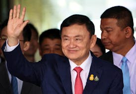 Former Thai Prime Minister Thaksin Shinawatra, who is expected to be arrested upon his return as he ends almost two decades of self-imposed exile, waves at Don Mueang airport in Bangkok, Thailand August 22, 2023.