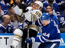 David Kampf (64) of the Toronto Maple Leafs checks David Pastrnak (88) of the Boston Bruins during the second period of Game 6 of the First Round of the 2024 Stanley Cup Playoffs at Scotiabank Arena on Thursday, May 2, 2024, in Toronto. 