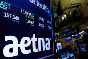 A logo of Aetna is displayed on a monitor above the floor of the New York Stock Exchange shortly after the opening bell in New York, U.S., December 5, 2017. 