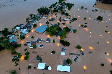 A drone view shows houses in the flooded area next to the Taquari River during heavy rains in the city of Encantado in Rio Grande do Sul, Brazil, May 1, 2024.