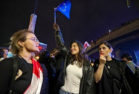 Mariam Tsertsvadze, a nonprofit worker in the Georgian capital, holds a flag of the European Union during a rally to protest against a bill on "foreign agents" in Tbilisi, Georgia May 2, 2024.