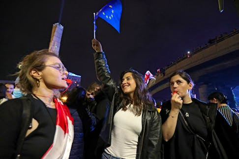 Mariam Tsertsvadze, a nonprofit worker in the Georgian capital, holds a flag of the European Union during a rally to protest against a bill on "foreign agents" in Tbilisi, Georgia May 2, 2024.