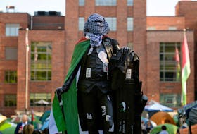 A statue of George Washington tied with a Palestinian flag and a keffiyeh inside a pro-Palestinian encampment is pictured at George Washington University in Washington, DC, U.S., May 2, 2024.
