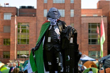 A statue of George Washington tied with a Palestinian flag and a keffiyeh inside a pro-Palestinian encampment is pictured at George Washington University in Washington, DC, U.S., May 2, 2024.