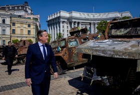 Britain's Foreign Secretary David Cameron walks past a display of destroyed Russian military vehicles in Saint Michael's Square, amid Russia's attack on Ukraine, in Kyiv, Ukraine, May 2, 2024.