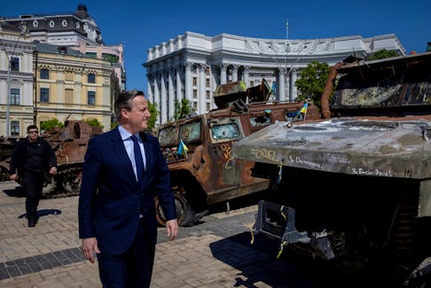 Britain's Foreign Secretary David Cameron walks past a display of destroyed Russian military vehicles in Saint Michael's Square, amid Russia's attack on Ukraine, in Kyiv, Ukraine, May 2, 2024.