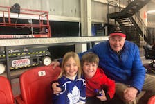 Thea Clark, left, Dezi Nemeth and a senior hockey fan enjoy the action at a Truro Bearcats - West Kent Streamers junior A hockey game. CONTRIBUTED