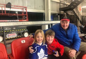Thea Clark, left, Dezi Nemeth and a senior hockey fan enjoy the action at a Truro Bearcats - West Kent Streamers junior A hockey game. CONTRIBUTED