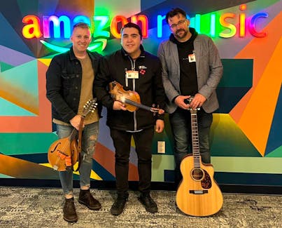 From left, Ryan Roberts, Morgan Toney and Keith Mullins stand in front of the Amazon Music logo in the company's 47th-floor office in Scotia Plaza in Toronto. Toney won Indigenous Artist of the Year on the first night of the ECMAs on Thursday and is also nominated for two more East Coast Music Awards, Fusion Recording of the Year and Roots/Traditional Recording of the Year. Mullins is also nominated for Producer of the Year.  CONTRIBUTED/MORGAN TONEY