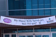 The Pictou County Women's Resource and Sexual Assault Centre hung a banner from the entrance of the Pictou County Wellness Centre, the banner reads "We Stand With Survivors" along with the phone number for the Women's Centre and a QR code that when scanned takes people to the center's website with available resources. -Sarah Jordan