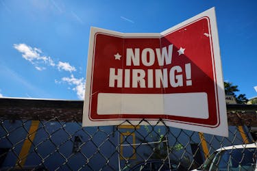 A "now hiring" sign is displayed outside Taylor Party and Equipment Rentals in Somerville, Massachusetts, U.S., September 1, 2022.    