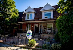 For sale sign is displayed outside a home in Toronto, Ontario, Canada June 15, 2021.