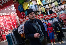 A man pauses in front of a shop in a popular middle-class shopping district in Istanbul, Turkey March 4, 2024.