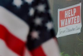 A “Help Wanted” sign hangs in restaurant window in Medford, Massachusetts, U.S., January 25, 2023.