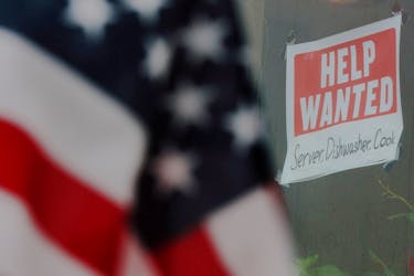 A “Help Wanted” sign hangs in restaurant window in Medford, Massachusetts, U.S., January 25, 2023.