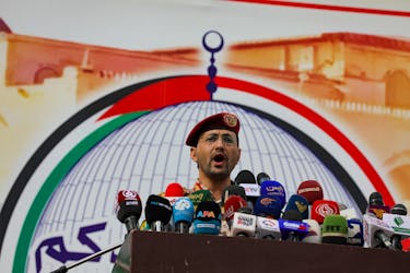 Yahya Sarea, the Houthi military spokesperson, delivers a statement, during a pro-Palestinian rally, saying they launched an attack on the "Pacific 01" ship in the Red Sea with missiles, in Sanaa, Yemen, March 15, 2024.