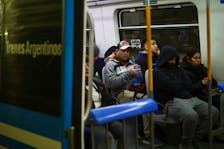 Commuters sit inside a train during a protest held by train workers driving trains at a reduced speed, causing delays at Retiro train station, in Buenos Aires, Argentina May 30, 2024.