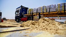 A truck delivers humanitarian aid using the Trident Pier, a temporary pier to deliver aid, off the Gaza Strip, amid the ongoing conflict between Israel and the Palestinian Islamist group Hamas, near the Gaza coast, May 18, 2024. U.S. Army Central/Handout via