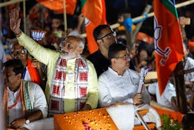 India's Prime Minister Narendra Modi waves towards his supporters during a roadshow as part of an election campaign, in Kolkata, India, May 28, 2024.