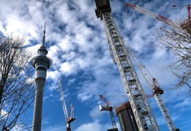 Cranes located on construction sites are seen near the Sky Tower building in central Auckland, New Zealand, June 25, 2017.